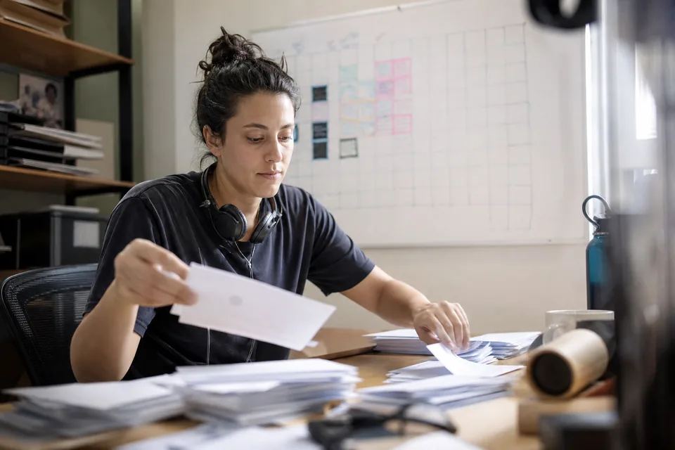 Support lead reviewing cancelled subscription notes on index cards